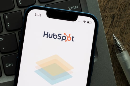 HubSpot on iPhone which is on a desk