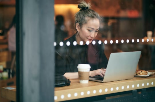girl using laptop inside a cafe