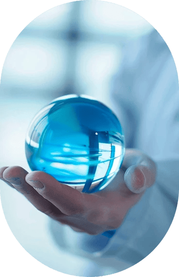 A hand holding a blue crystal ball